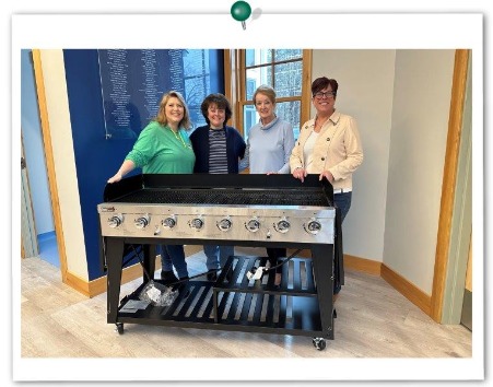 IFS employees donate a new grill to COA. Pictured from COA: Lisa Giugliano (left) and Chris Cable (right)